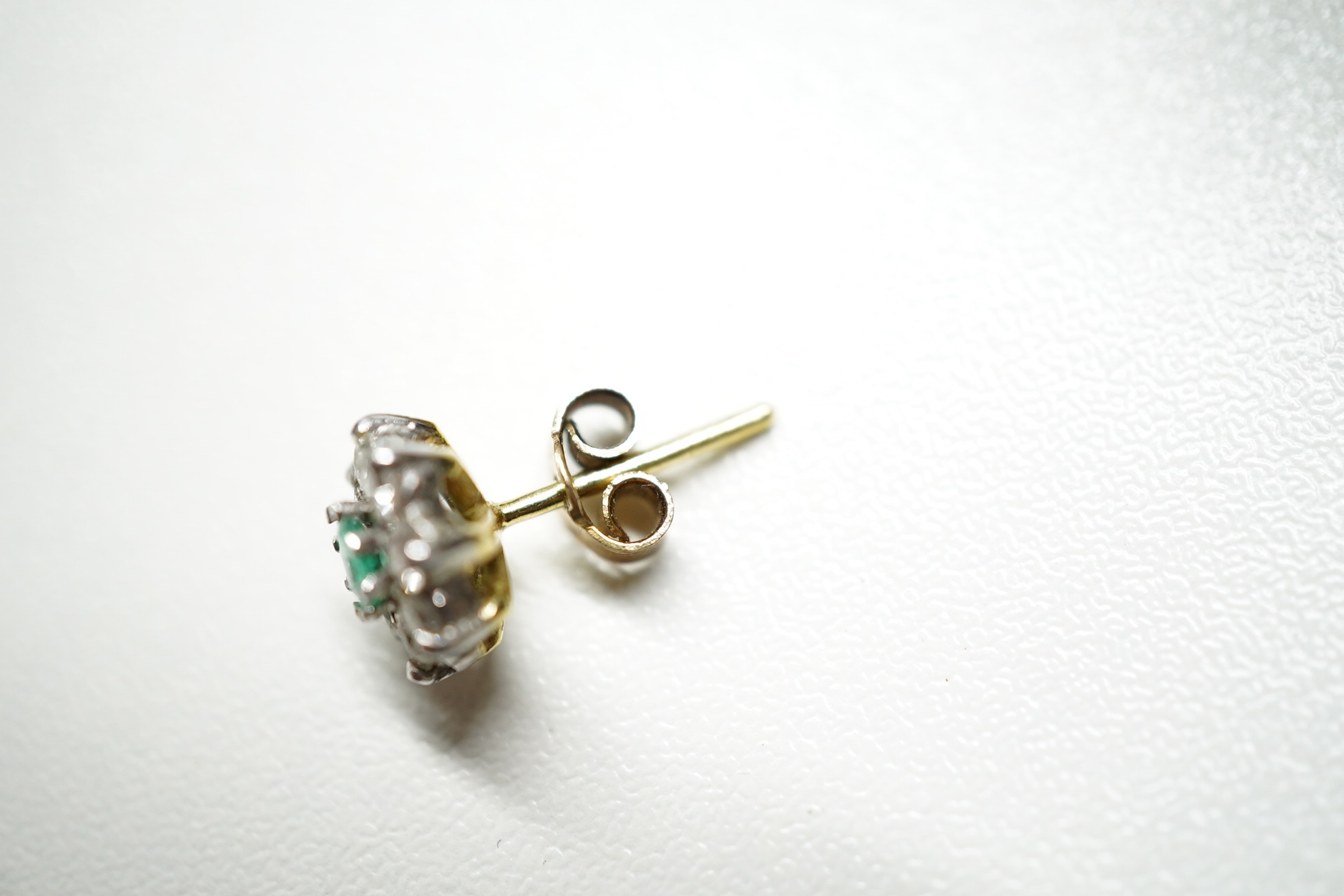 A modern pair of 9ct, emerald and diamond set flower head cluster ear studs, 8mm and a similar pair of sapphire and diamond cluster ear studs. Condition - fair to good